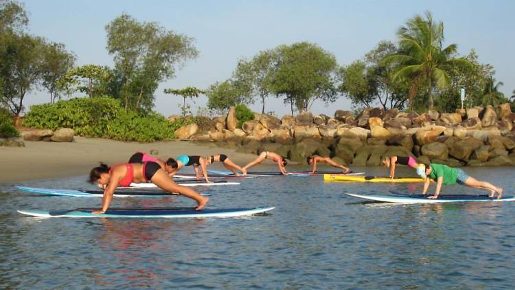 Paddle around on a surfboard at SUP School