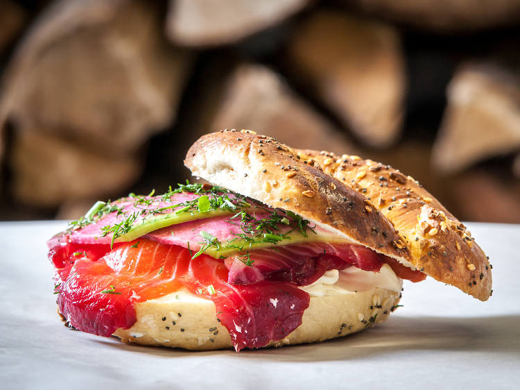 Beet-cured salmon sandwich on an everything bagel at Black Seed Bagels