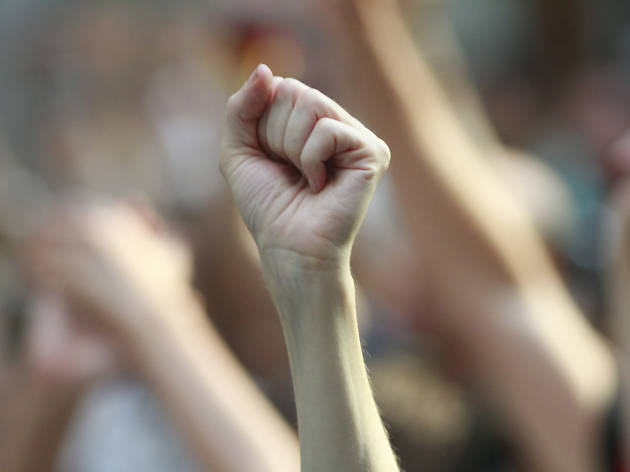 A fist raised in solidarity at a protest.