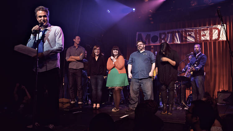 Host Dave Nadelberg on stage with 'Mortified' performers