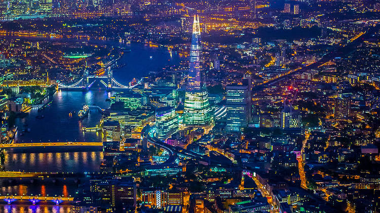 Aerial photo of the Shard and Thames at night.
