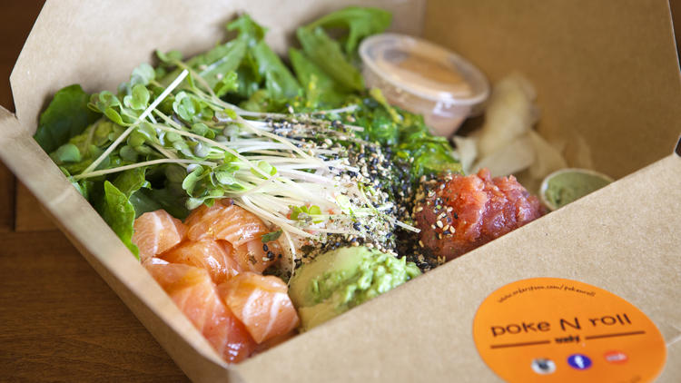 Salmon and spicy tuna with avocado, seaweed salad and sprouts at