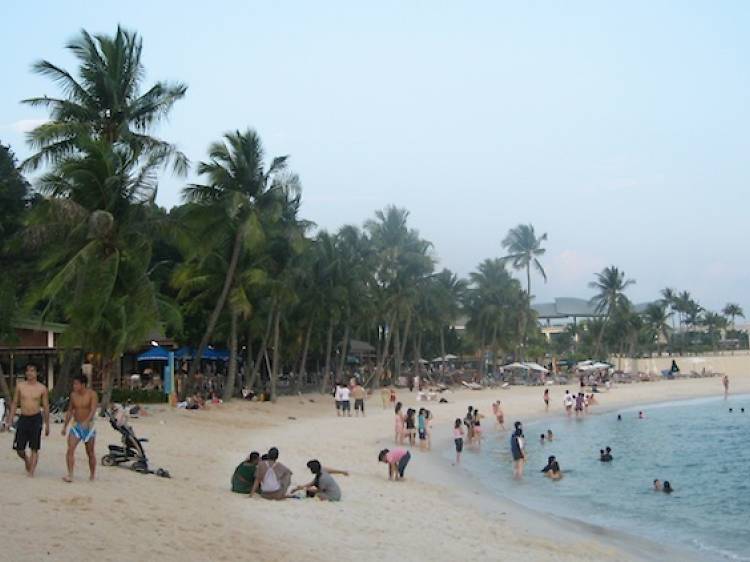 Build sandcastles at Siloso Beach