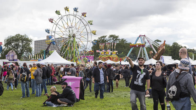 Attendees walk through the midway at day one of Riot Fest.