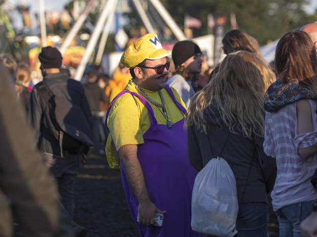 Crowds trudged through muddy fields during the second day of Riot Fest, September 12, 2015.