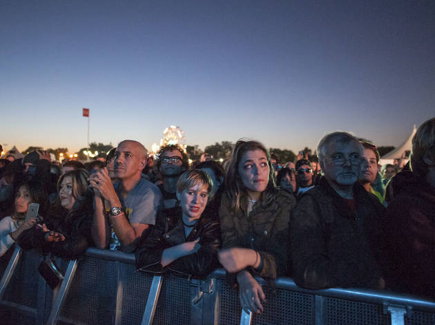 Crowds trudged through muddy fields during the second day of Riot Fest, September 12, 2015.