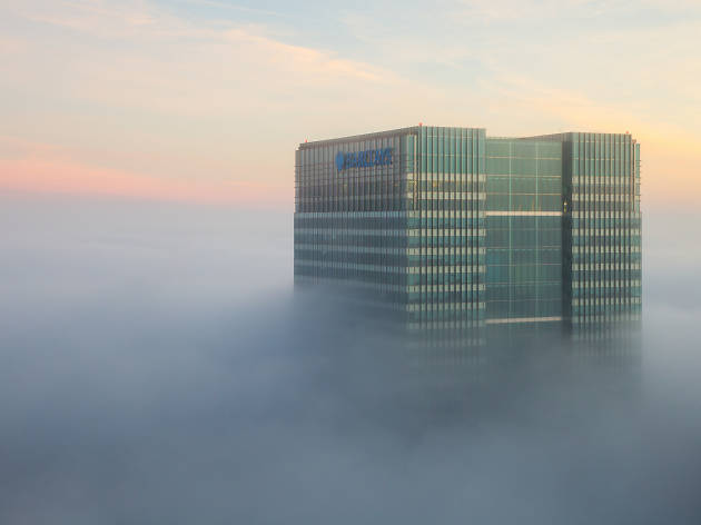 Barclays skyscraper through the fog in London. Barclays skyscraper through the fog in London.