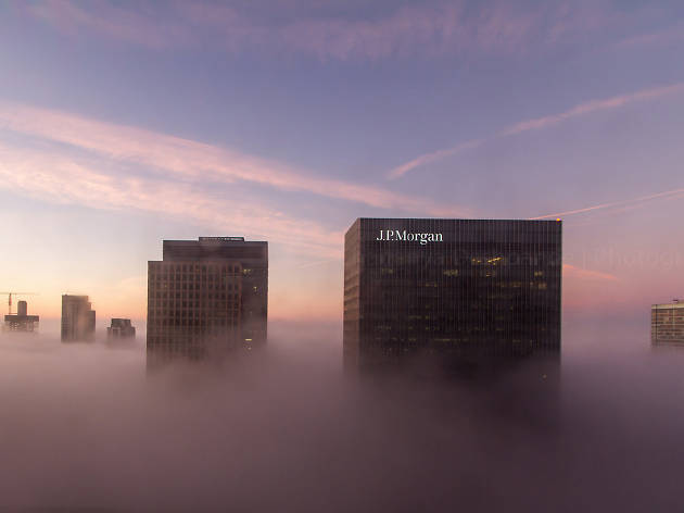 Skyscrapers in Canary Wharf emerge through the mist. Skyscrapers in Canary Wharf emerge through the mist.