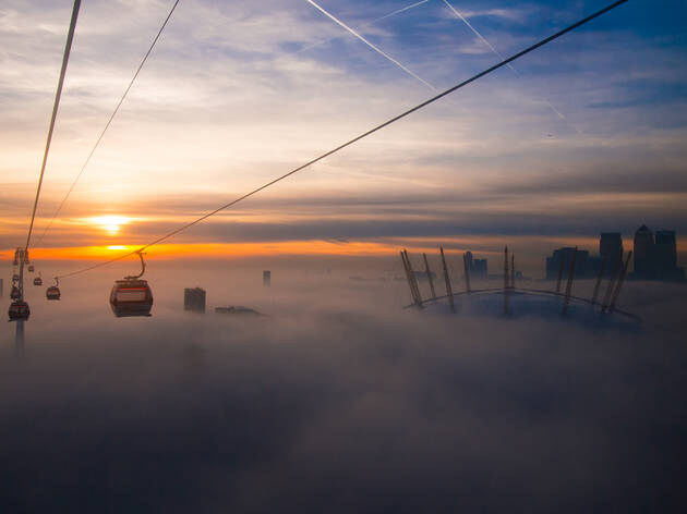 Fog around Millennium Bridge, obscuring the view of St. Paul's Cathedral Fog appears to make London's cable car, or the Emirates Air Line, appear to float above the clouds.