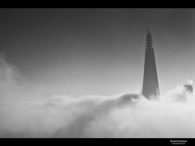 The Shard casts a long shadow over London fog. The Shard casts a long shadow over London fog.