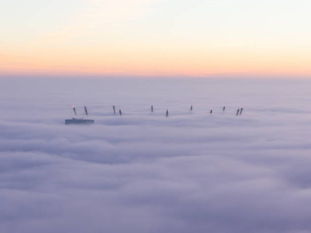 The masts of the O2 Arena, Greenwich, through the fog, in London. The masts of the O2 Arena, Greenwich, through the fog, in London.