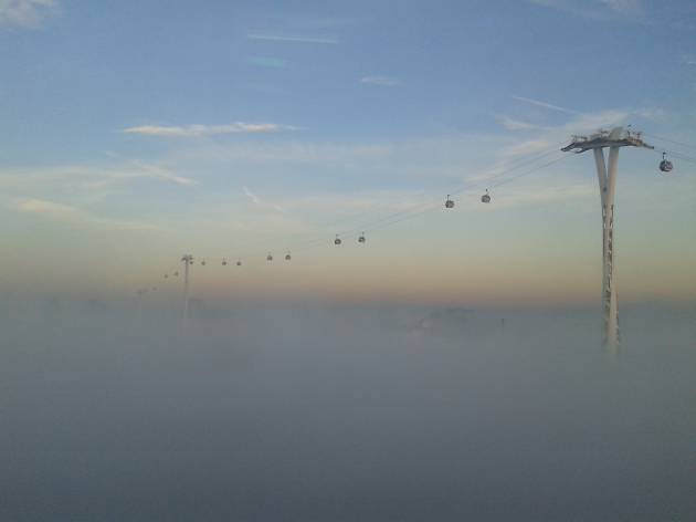 The Emirates Air Line cable car above the mist in east London. The Emirates Air Line cable car above the mist in east London.