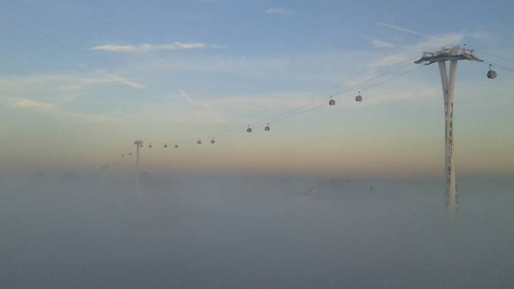 The Emirates Air Line cable car above the mist in east London.