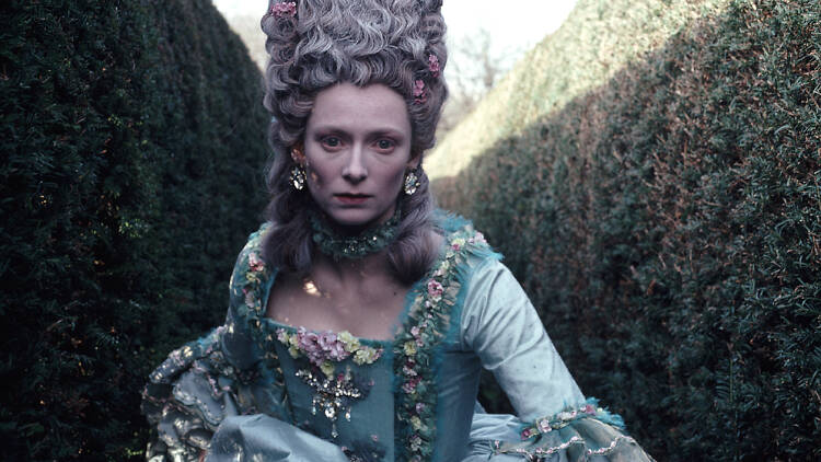 A still from the film Orlando of a Georgian woman running through a maze