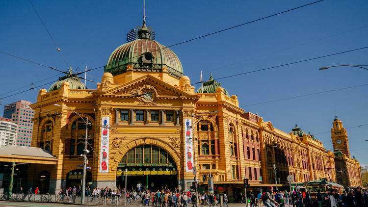 Flinders Street Station during the day seen from the corner of Flinders and Swanston Street