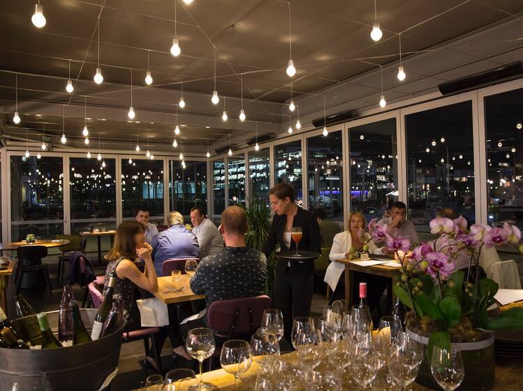 An interior shot at LuMi showing a room of people sitting at tab