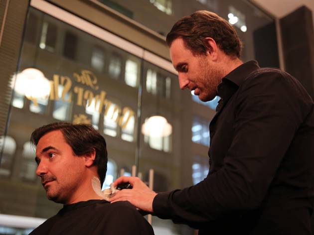 Shave at The Barber Shop Man getting a close shave