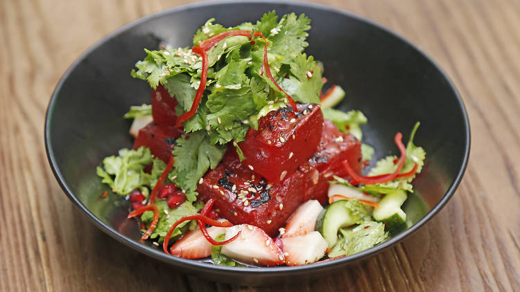 Grilled watermelon with pomegranate, mint leaf, cucumber and strawberry at Bakar