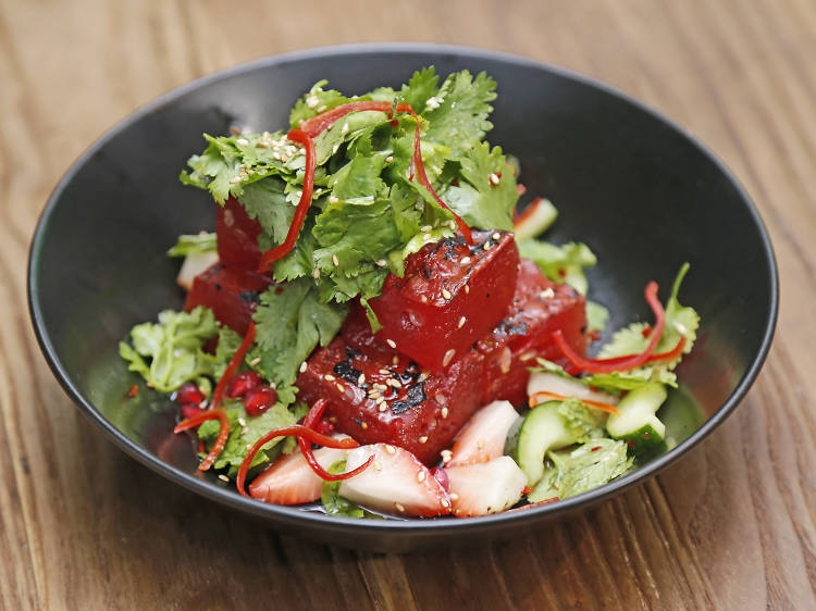 Grilled watermelon with pomegranate, mint leaf, cucumber and strawberry at Bakar