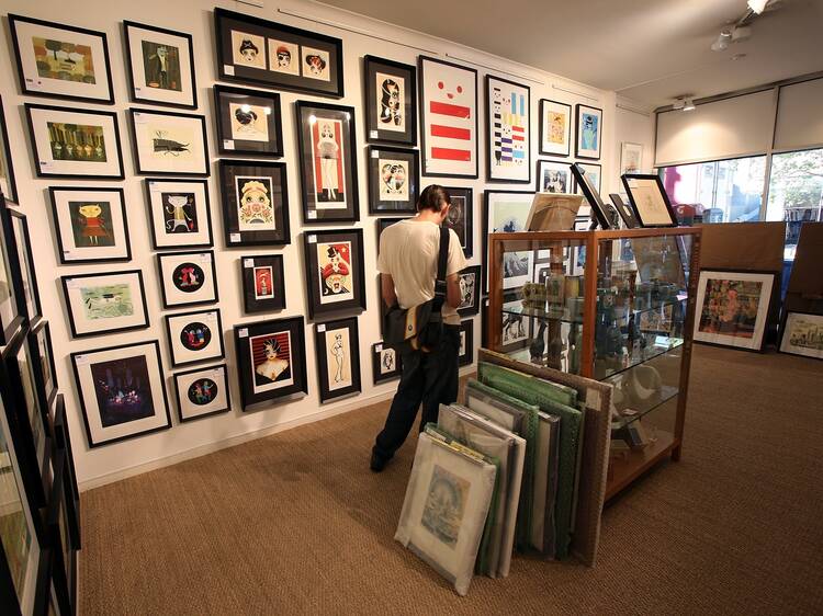 An interior shot at Outre Gallery showing a man browsing a wall