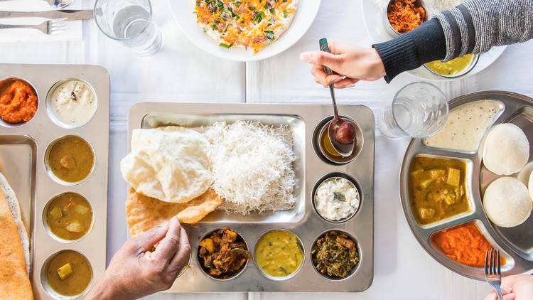 A top down shot of Thali at Janani. Multiple hands are in frame