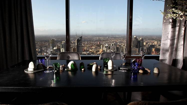 An interior shot of a table setting in front of a full length wi