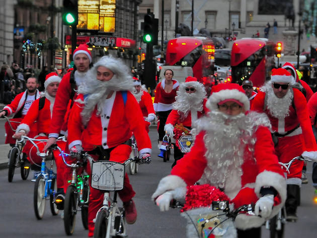 Santas on their bikes ride down Whitehall. Santas on their bikes ride down Whitehall.