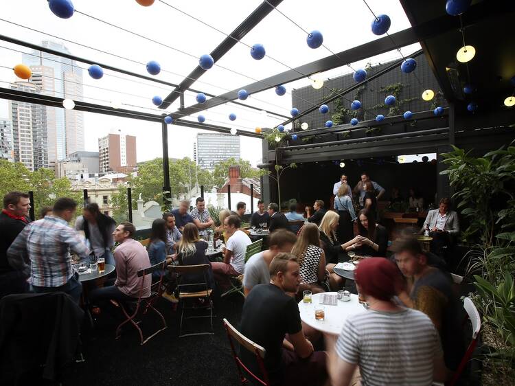 An exterior shot of the rooftop at Loop Roof showing people sitt