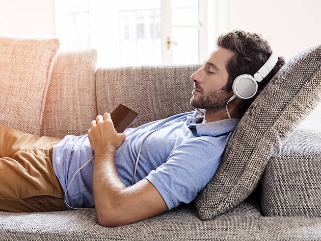 Listening to music on couch Photograph: Shutterstock