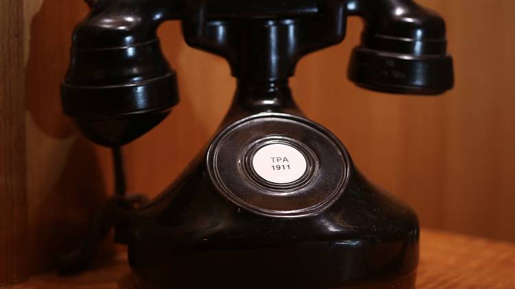 A vintage black telephone on a table at Bar Exuberante