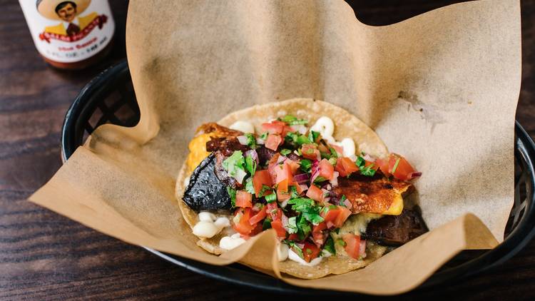 Portabello mushroom taco topped with guacamole and salsa