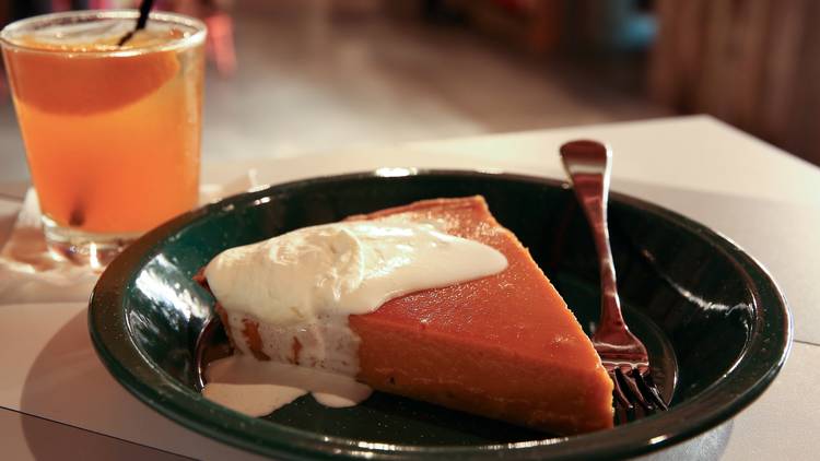 Pumpkin pie topped with cream