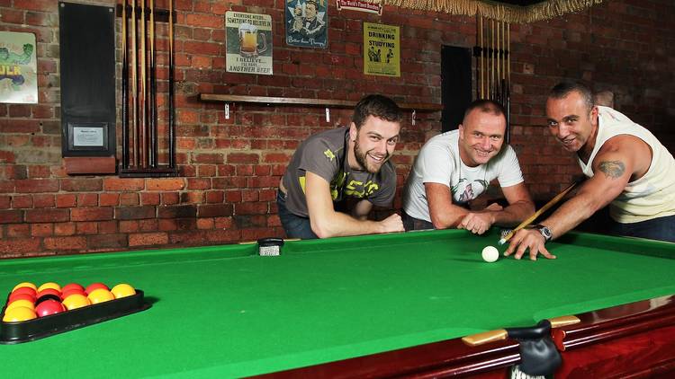 A group of three men playing pool at Sircuit Bar