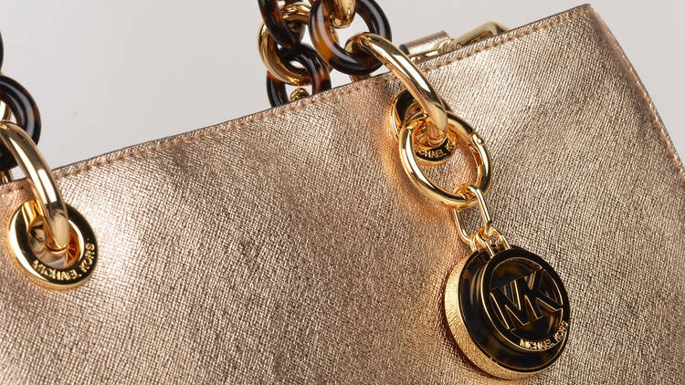 A golden handbag with gold accessories