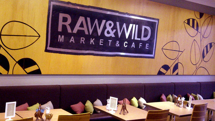 An interior shot of booth seats and tables at Raw & Wild