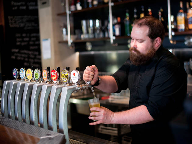 Bartender at Beer Deluxe Hawthorne Bartender pours a beer from a tap