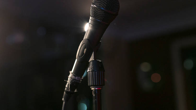 A mic stands on stage