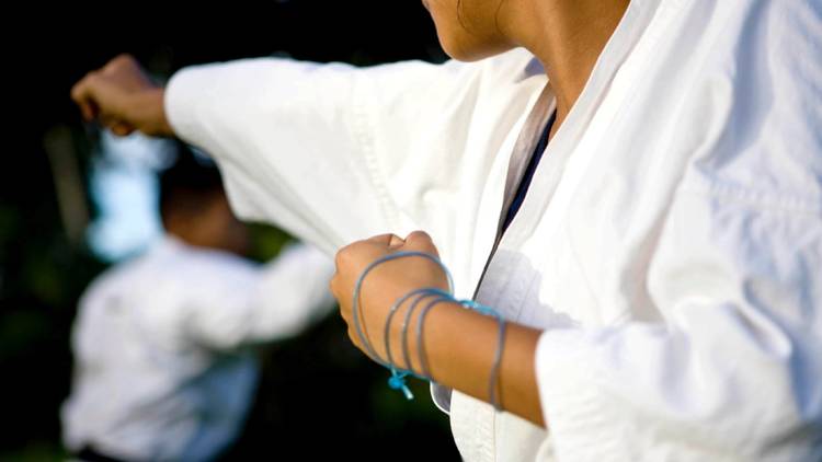 A close up shot of a woman practicing martial arts