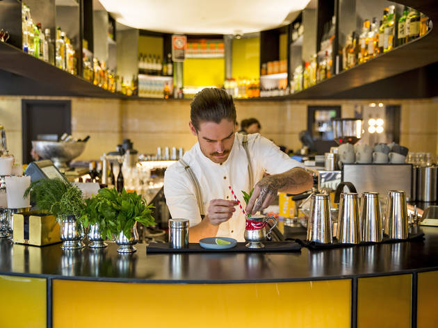 The Old Clare bartender Bartender putting a mint garnish in a cocktail at The Old Clare