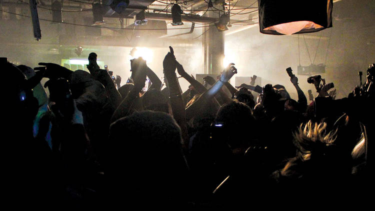 People dancing inside of a dark club