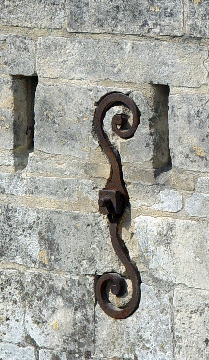 What are those ugly diamonds bolted onto the side of old buildings?