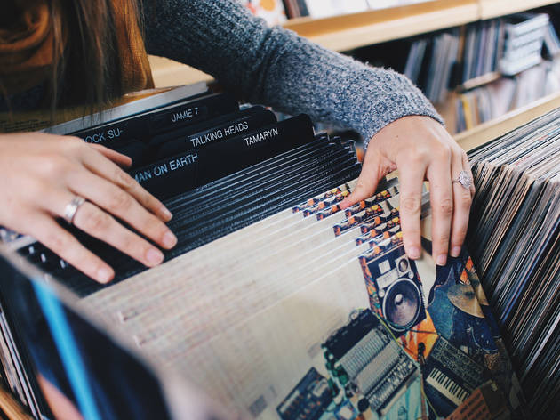 Generic vinyl record store A woman searches through the vinyl collection in a record store