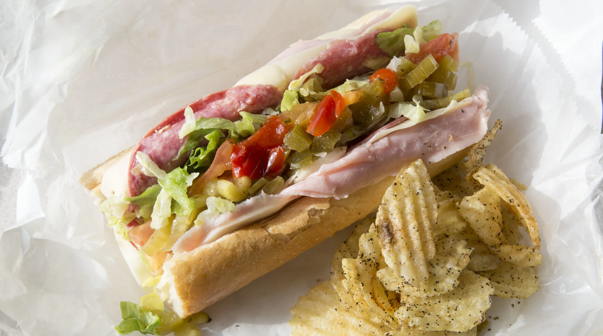 A sub sandwich and chips