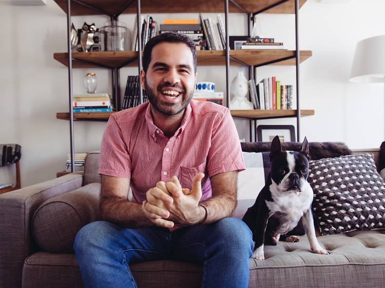 Giuseppe Santamaria with his dog Baxter on the couch