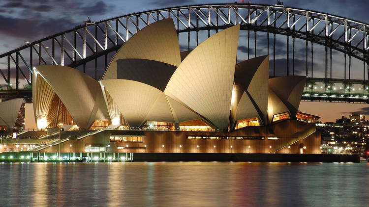 The Opera House at twilight, with the harbour bridge behind it.