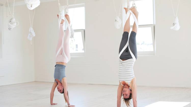 Practise yoga while hanging upside down from the ceiling