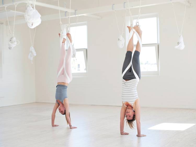 Practise yoga while hanging upside down from the ceiling
