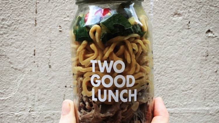 A jar filled with egg noodles and salad