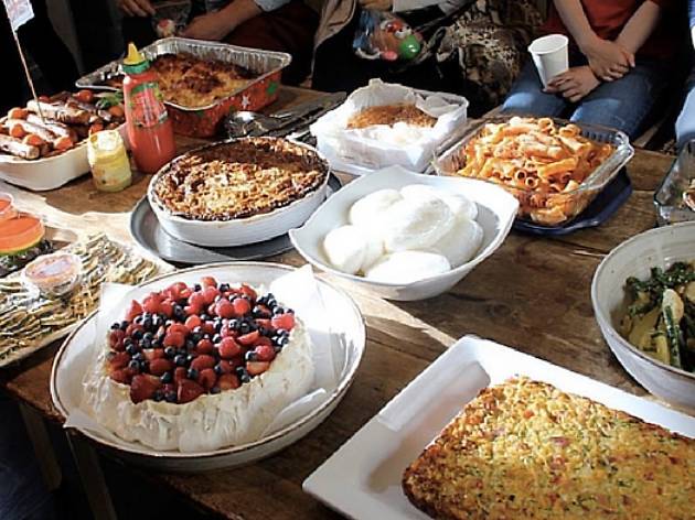 Dinner at the Welcome Dinner Project Buffet table featuring salad, pasta and pavlova