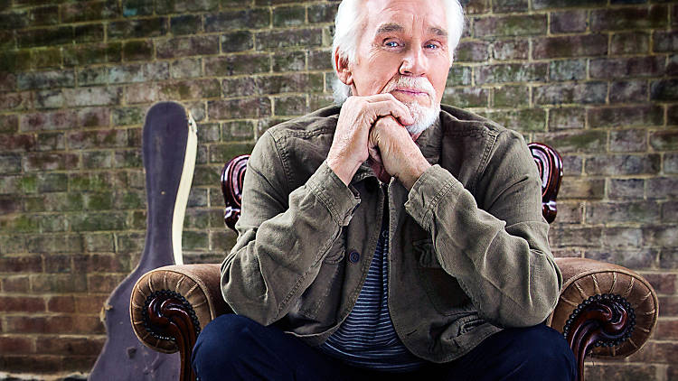 Kenny Rogers sitting in a chair